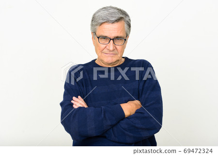 Portrait of handsome senior man wearing eyeglasses with arms crossed Portrait of handsome senior man wearing eyeglasses with arms crossed 69472324