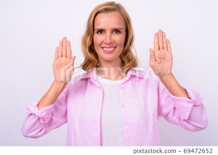 Portrait of happy beautiful blonde woman showing palm of hands Portrait of happy beautiful blonde woman showing palm of hands 69472652