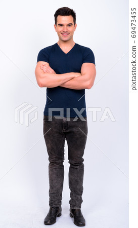 Full body shot of happy young handsome man smiling with arms crossed Full body shot of happy young handsome man smiling with arms crossed 69473455