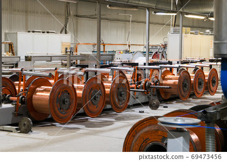 Production of copper wire, bronze cable in reels at factory Production of copper wire, bronze cable in reels at factory 69473456