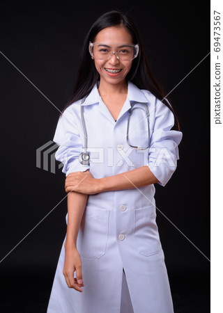 Portrait of happy young Asian woman doctor as scientist smiling Portrait of happy young Asian woman doctor as scientist smiling 69473567
