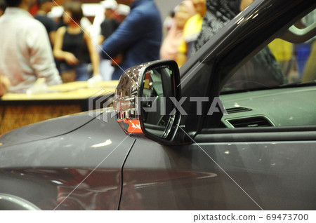 KUALA LUMPUR, MALAYSIA -NOVEMBER 12, 2017: Car side mirror or door mirror build at extrior of car for the purposes of helping the driver see areas behind and to the sides of the vehicle. KUALA LUMPUR, MALAYSIA -NOVEMBER 12, 2017: Car side mirror or door mirror build at extrior of car for the purposes of helping the driver see areas behind and to the sides of the vehicle. 69473700