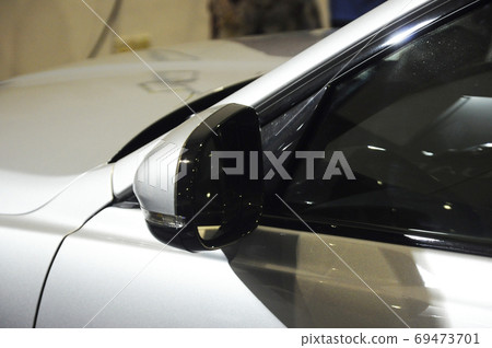 KUALA LUMPUR, MALAYSIA -NOVEMBER 12, 2017: Car side mirror or door mirror build at extrior of car for the purposes of helping the driver see areas behind and to the sides of the vehicle. KUALA LUMPUR, MALAYSIA -NOVEMBER 12, 2017: Car side mirror or door mirror build at extrior of car for the purposes of helping the driver see areas behind and to the sides of the vehicle. 69473701