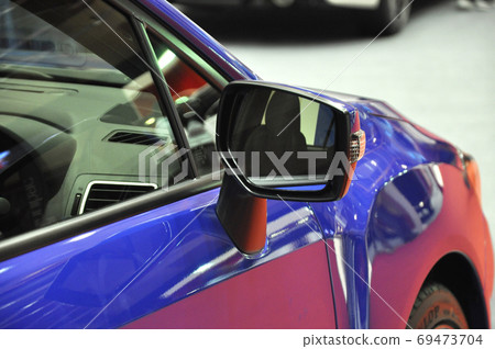 KUALA LUMPUR, MALAYSIA -NOVEMBER 12, 2017: Car side mirror or door mirror build at extrior of car for the purposes of helping the driver see areas behind and to the sides of the vehicle. KUALA LUMPUR, MALAYSIA -NOVEMBER 12, 2017: Car side mirror or door mirror build at extrior of car for the purposes of helping the driver see areas behind and to the sides of the vehicle. 69473704