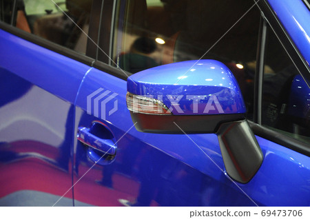 KUALA LUMPUR, MALAYSIA -NOVEMBER 12, 2017: Car side mirror or door mirror build at extrior of car for the purposes of helping the driver see areas behind and to the sides of the vehicle. KUALA LUMPUR, MALAYSIA -NOVEMBER 12, 2017: Car side mirror or door mirror build at extrior of car for the purposes of helping the driver see areas behind and to the sides of the vehicle. 69473706