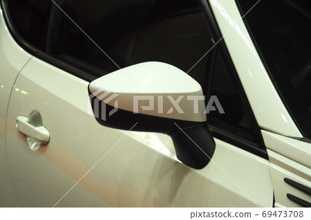 KUALA LUMPUR, MALAYSIA -NOVEMBER 12, 2017: Car side mirror or door mirror build at extrior of car for the purposes of helping the driver see areas behind and to the sides of the vehicle. KUALA LUMPUR, MALAYSIA -NOVEMBER 12, 2017: Car side mirror or door mirror build at extrior of car for the purposes of helping the driver see areas behind and to the sides of the vehicle. 69473708