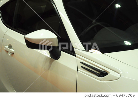 KUALA LUMPUR, MALAYSIA -NOVEMBER 12, 2017: Car side mirror or door mirror build at extrior of car for the purposes of helping the driver see areas behind and to the sides of the vehicle. KUALA LUMPUR, MALAYSIA -NOVEMBER 12, 2017: Car side mirror or door mirror build at extrior of car for the purposes of helping the driver see areas behind and to the sides of the vehicle. 69473709
