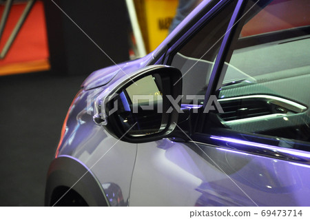 KUALA LUMPUR, MALAYSIA -NOVEMBER 12, 2017: Car side mirror or door mirror build at extrior of car for the purposes of helping the driver see areas behind and to the sides of the vehicle. KUALA LUMPUR, MALAYSIA -NOVEMBER 12, 2017: Car side mirror or door mirror build at extrior of car for the purposes of helping the driver see areas behind and to the sides of the vehicle. 69473714