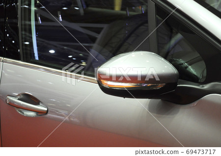 KUALA LUMPUR, MALAYSIA -NOVEMBER 12, 2017: Car side mirror or door mirror build at extrior of car for the purposes of helping the driver see areas behind and to the sides of the vehicle. KUALA LUMPUR, MALAYSIA -NOVEMBER 12, 2017: Car side mirror or door mirror build at extrior of car for the purposes of helping the driver see areas behind and to the sides of the vehicle. 69473717