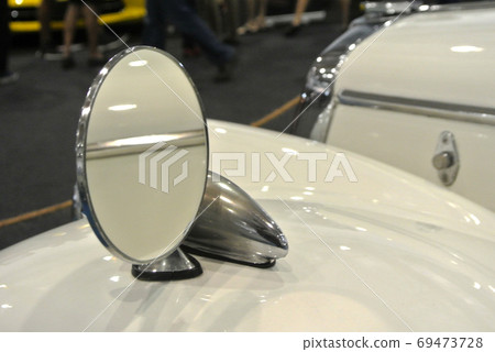 KUALA LUMPUR, MALAYSIA -NOVEMBER 12, 2017: Car side mirror or door mirror build at extrior of car for the purposes of helping the driver see areas behind and to the sides of the vehicle. KUALA LUMPUR, MALAYSIA -NOVEMBER 12, 2017: Car side mirror or door mirror build at extrior of car for the purposes of helping the driver see areas behind and to the sides of the vehicle. 69473728