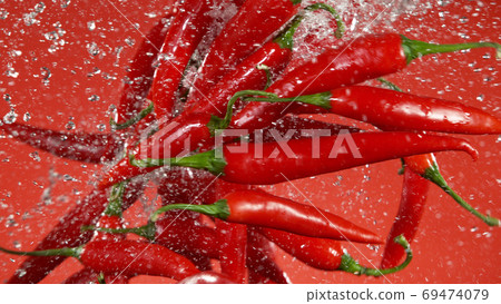 Freeze motion of flying chilli peppers in the air 69474079