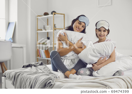 Happy mother and daughter on bed in morning 69474399