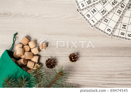 Wooden lotto barrels with bag and game cards on gray background Wooden lotto barrels with bag and game cards on gray background 69474545