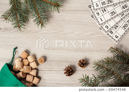 Wooden lotto barrels with bag and game cards on gray background Wooden lotto barrels with bag and game cards on gray background 69474546