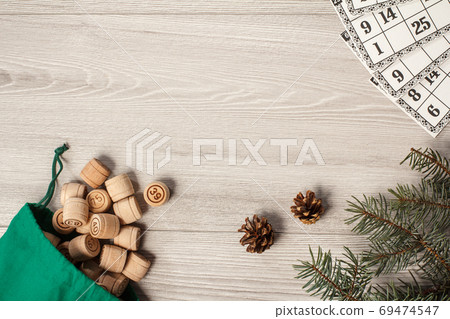 Wooden lotto barrels with bag and game cards on gray background Wooden lotto barrels with bag and game cards on gray background 69474547