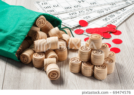 Wooden lotto barrels with bag, game cards and red chops for a game in lotto Wooden lotto barrels with bag, game cards and red chops for a game in lotto 69474576