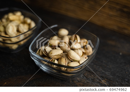 Almond, cachew and walnut in a small plates which standing on a black table. Nuts is a healthy vegetarian protein and nutritious food. Almond, cachew and walnut in a small plates which standing on a black table. Nuts is a healthy vegetarian protein and nutritious food. 69474962