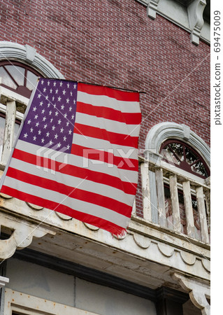 American flag in front of old style building American flag in front of old style building 69475009