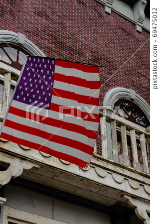 American flag in front of old style building American flag in front of old style building 69475012