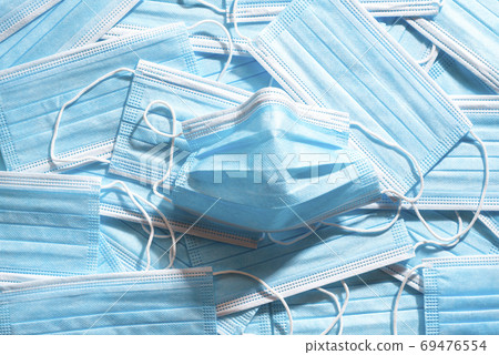 Medical masks top view. Pile of blue protective masks Medical masks top view. Pile of blue protective masks 69476554