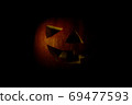 jack o lantern big orange pumpkin on a black background in low key 69477593
