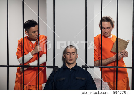 Two prisoners plan to attack a uniformed guard to escape from a maximum security prison 69477963