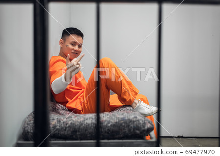 A crazy member of a Chinese mafia gang sits in - Stock