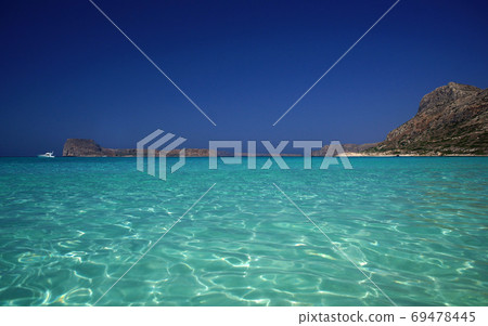 Amazing idyllic view of shiny turquoise sea water, of rocky coast, horizon, bright blue sky. Paradise holidays on ocean 69478445