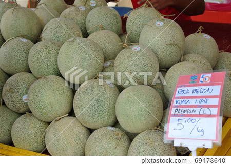 KUALA LUMPUR, MALAYSIA -NOVEMBER 01, 2017: A pile of cantaloupe or rockmelon fruit or the scientific name is Cucumis melo var. cantaloupe.  69478640