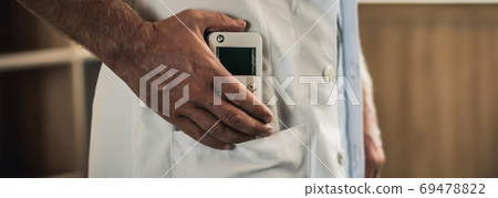 Young man hands hold bio rezonans therapy alternative medicine device, small portable life balance bioresonance for treatment Diseases of the intestinal system Young man hands hold bio rezonans therapy alternative medicine device, small portable life balance bioresonance for treatment Diseases of the intestinal system 69478822