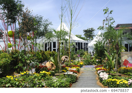 PUTRAJAYA, MALAYSIA -MAY 30, 2017: Pedestrian walkway at the public park. Decorated with flowers and shaded with trees.  69478837