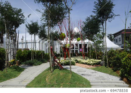 PUTRAJAYA, MALAYSIA -MAY 30, 2017: Pedestrian walkway at the public park. Decorated with flowers and shaded with trees.  69478838