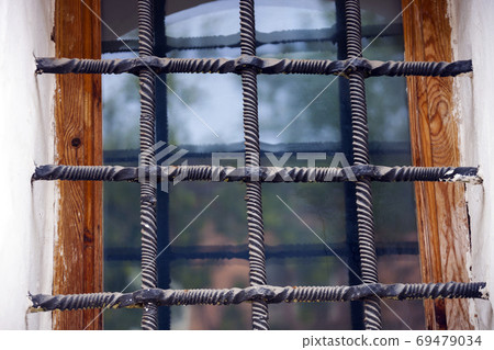 Ancient window with metal bars. Pskov, Russia, Ancient window with metal bars. Pskov, Russia, 69479034