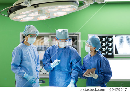 Medical staff performing surgery Medical staff performing surgery 69479947