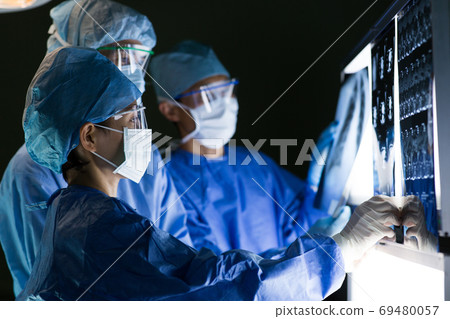 Medical staff performing surgery Medical staff performing surgery 69480057
