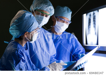 Medical staff performing surgery 69480147