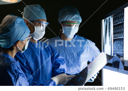 Medical staff performing surgery Medical staff performing surgery 69480153