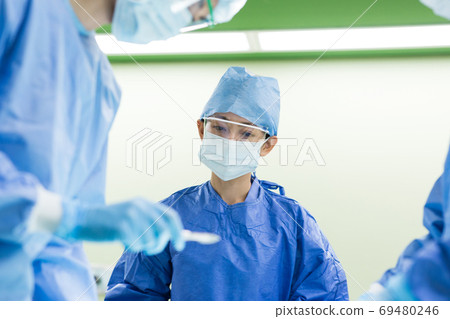 Medical staff performing surgery Medical staff performing surgery 69480246