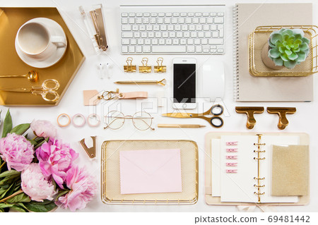 Neatly arranged office stationery with modern gadgets, devices, coffee and flowers on white desk. Neatly arranged office stationery with modern gadgets, devices, coffee and flowers on white desk. 69481442
