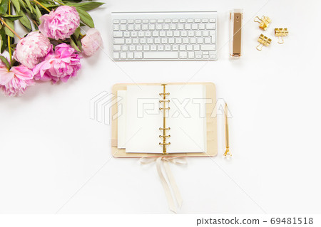 Neatly arranged office stationery with modern gadgets, devices, coffee and flowers on white desk. Neatly arranged office stationery with modern gadgets, devices, coffee and flowers on white desk. 69481518