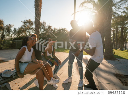 Group of young modern african black friends happily sitting together 69482118