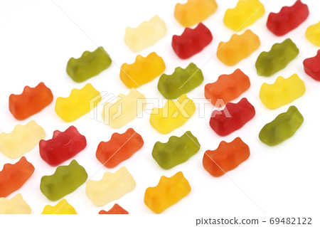Various colored jelly and candies on a white background 69482122