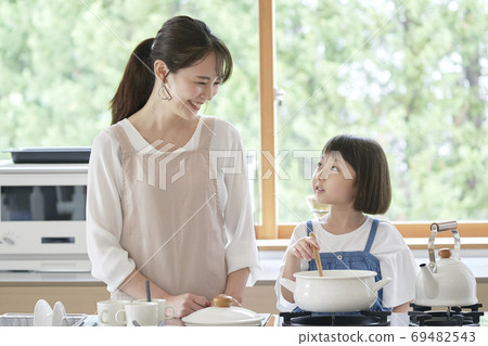 Mother and girl cooking Mother and girl cooking 69482543