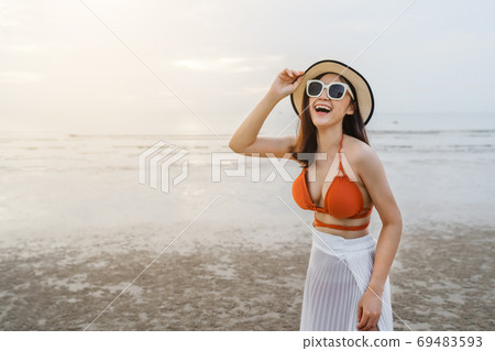 cheerful woman in bikini enjoying on sea beach 69483593