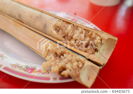 rice cooked in bamboo tubes rice cooked in bamboo tubes 69483675