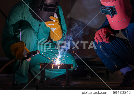 Metal welding steel works using electric arc welding machine 69483843
