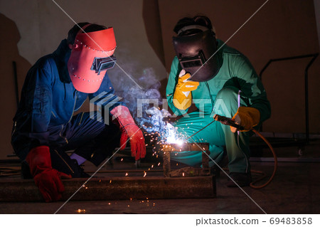 Metal welding steel works using electric arc welding machine Metal welding steel works using electric arc welding machine 69483858