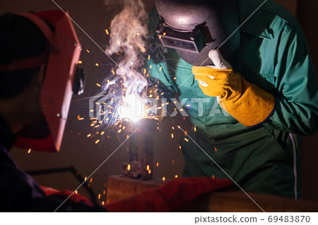 Metal welding steel works using electric arc welding machine 69483870