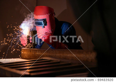 Metal welding steel works using electric arc welding machine 69483920