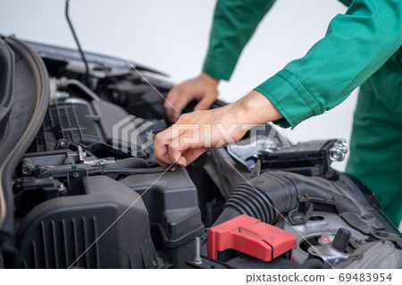 Professional mechanic hand providing car repair and maintenance service Professional mechanic hand providing car repair and maintenance service 69483954